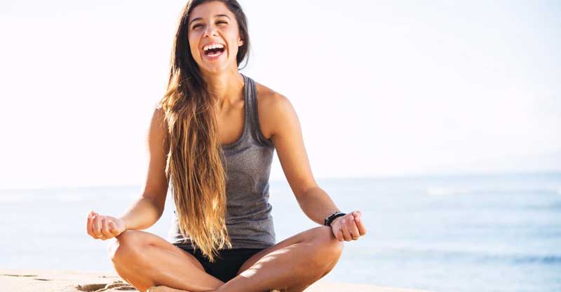 Woman smiling while meditating