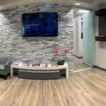 Wide shot of our lobby and front area with comfortable seating and large screen TV.